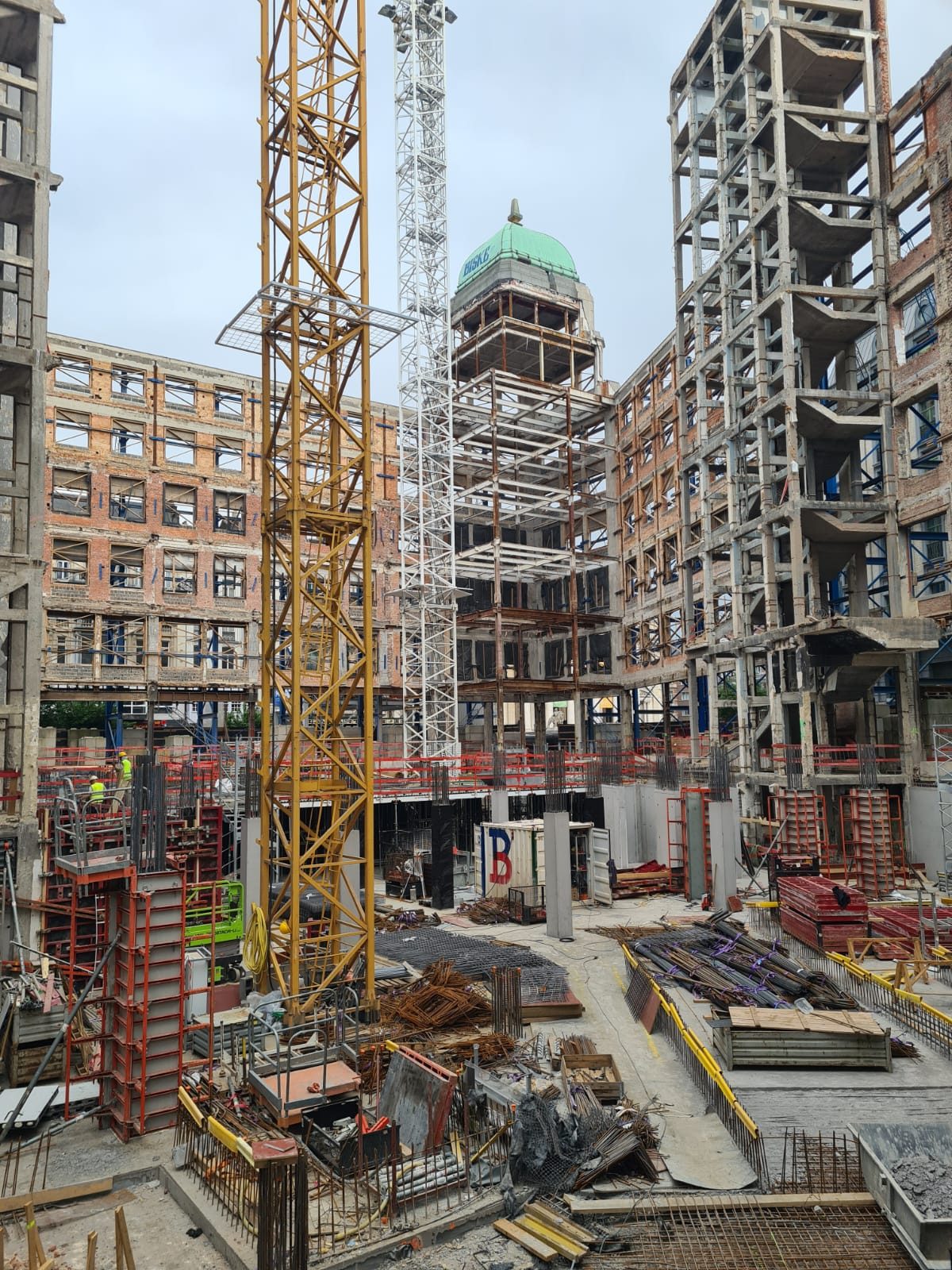Urban construction site with formwork, scaffolding and dome in the background