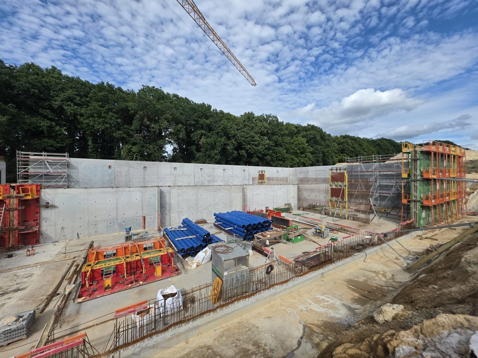 Reservoir construction site with concrete walls and formwork panels