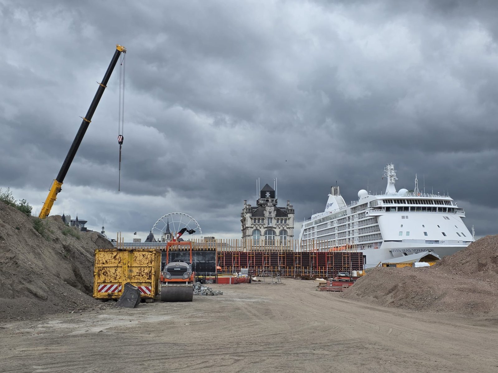 Quayside construction site with crane and ship in the background